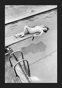 Black and white photograph of woman on trampoline above pool-5