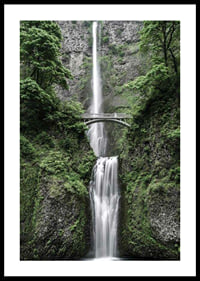 High waterfall with stone bridge, surrounded by greenery, photographic-0