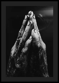 Black and white close-up of worn, dirty hands in prayer position-0
