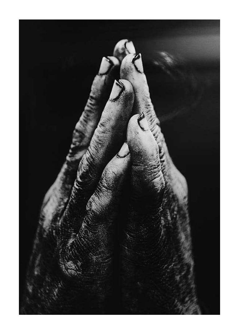 Black and white close-up of worn, dirty hands in prayer position-12