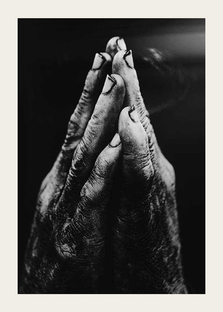 Black and white close-up of worn, dirty hands in prayer position-12