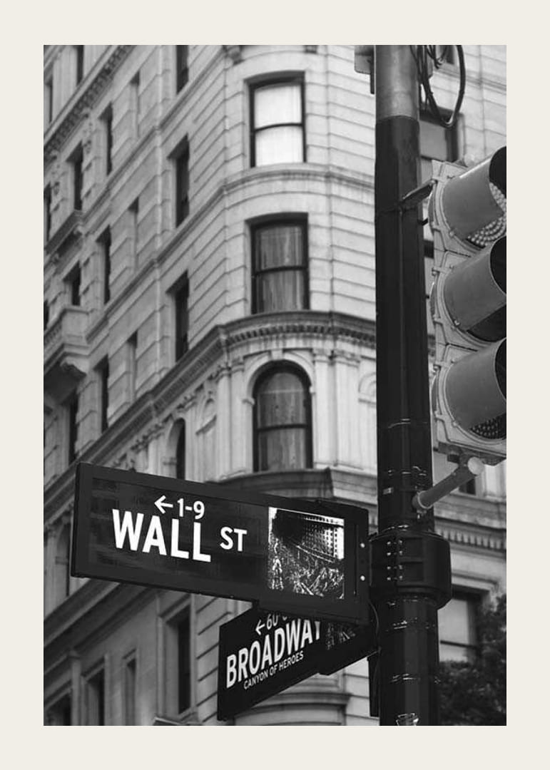 Black and white photographed road sign with text Wall Street-12