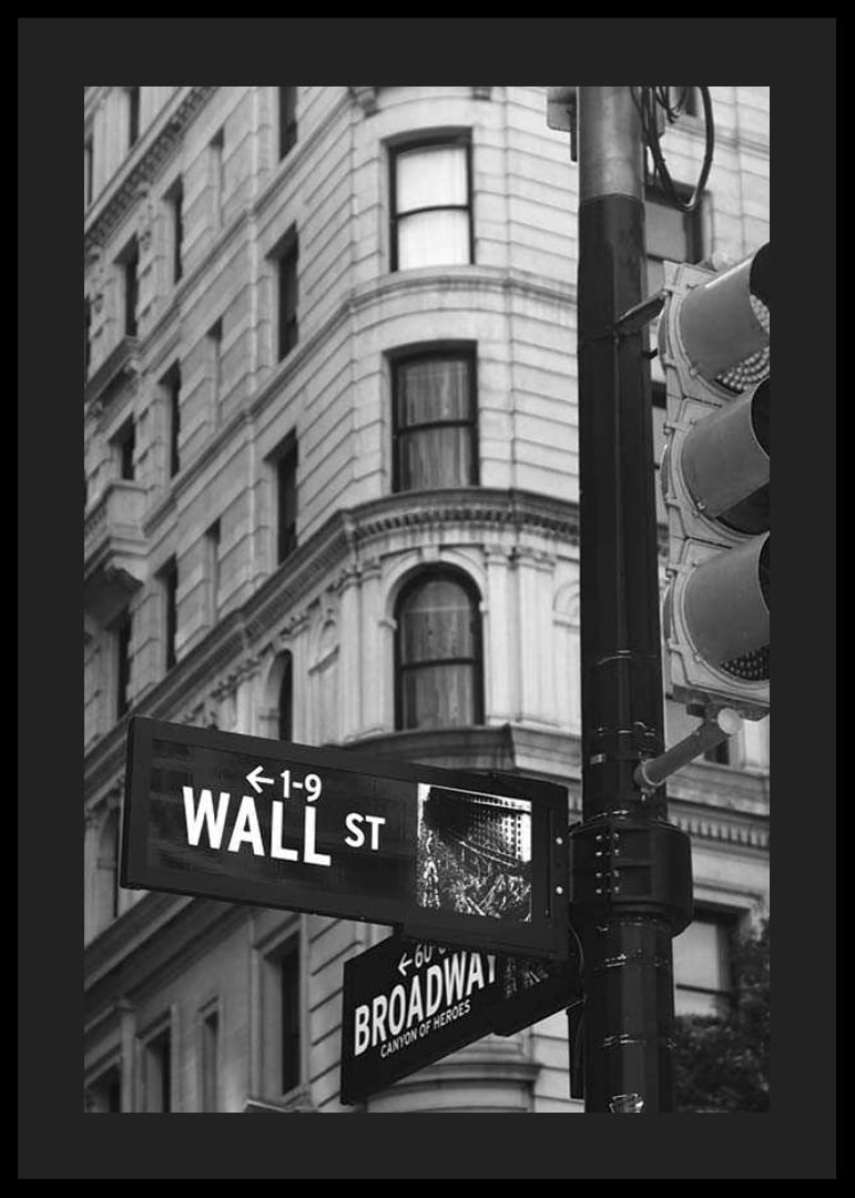 Black and white photographed road sign with text Wall Street-12