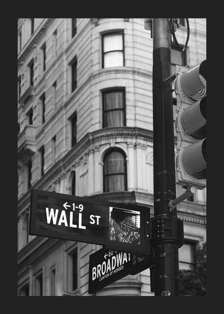 Black and white photographed road sign with text Wall Street-12