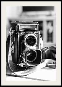 Black and white close-up of vintage two-lens analog camera on table-2