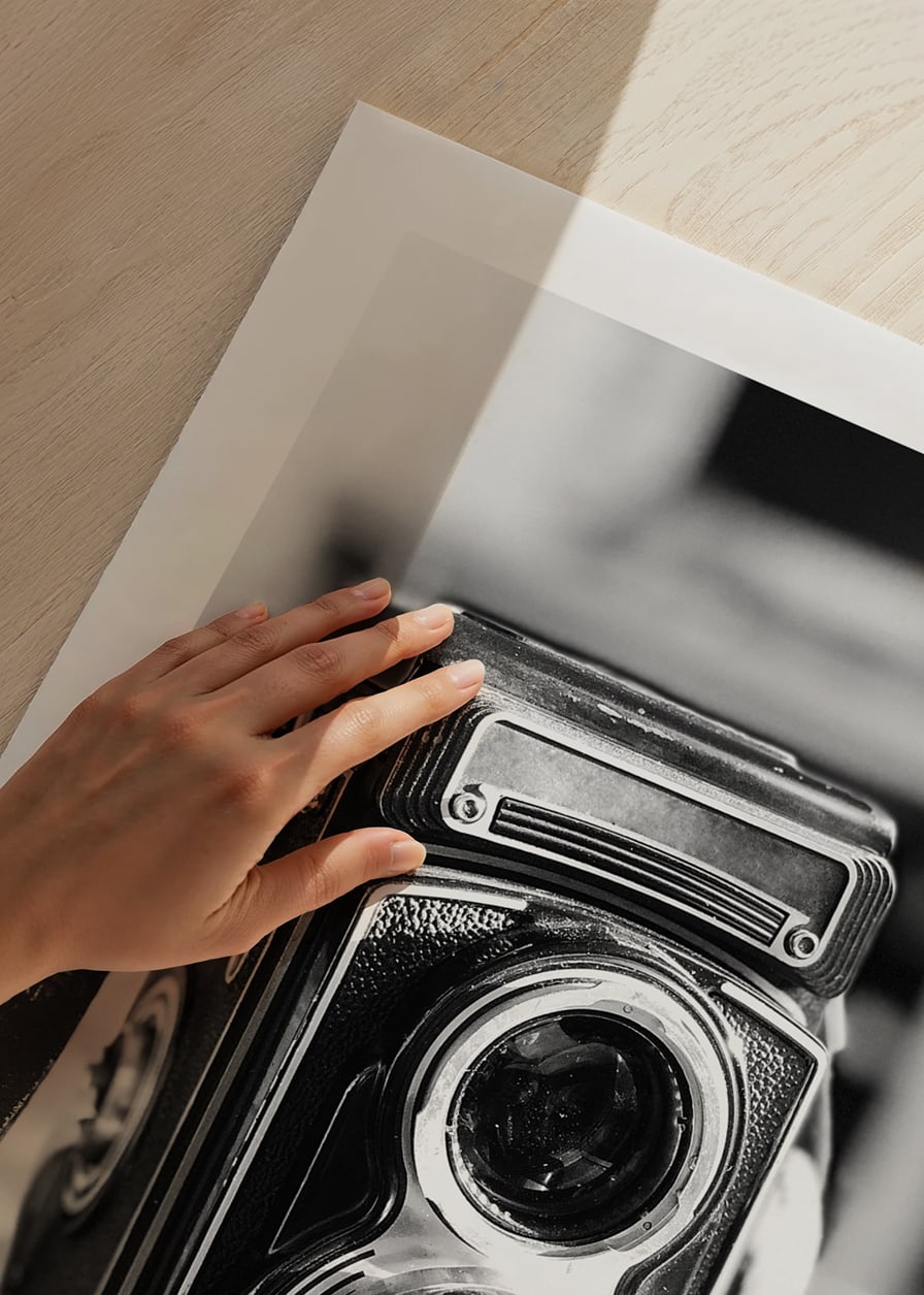 Black and white close-up of vintage two-lens analog camera on table-12