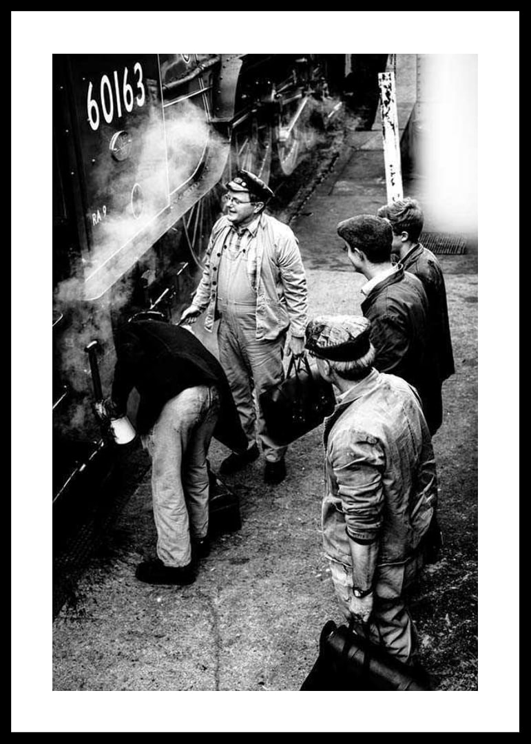 Black and white photo of men by steam locomotive on railway platform-12