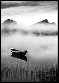 Black and white rowboat on foggy lake with mountains in the background-6
