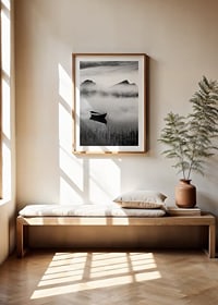 Black and white rowboat on foggy lake with mountains in the background-8