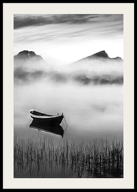 Black and white rowboat on foggy lake with mountains in the background-2