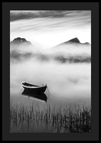 Black and white rowboat on foggy lake with mountains in the background-4