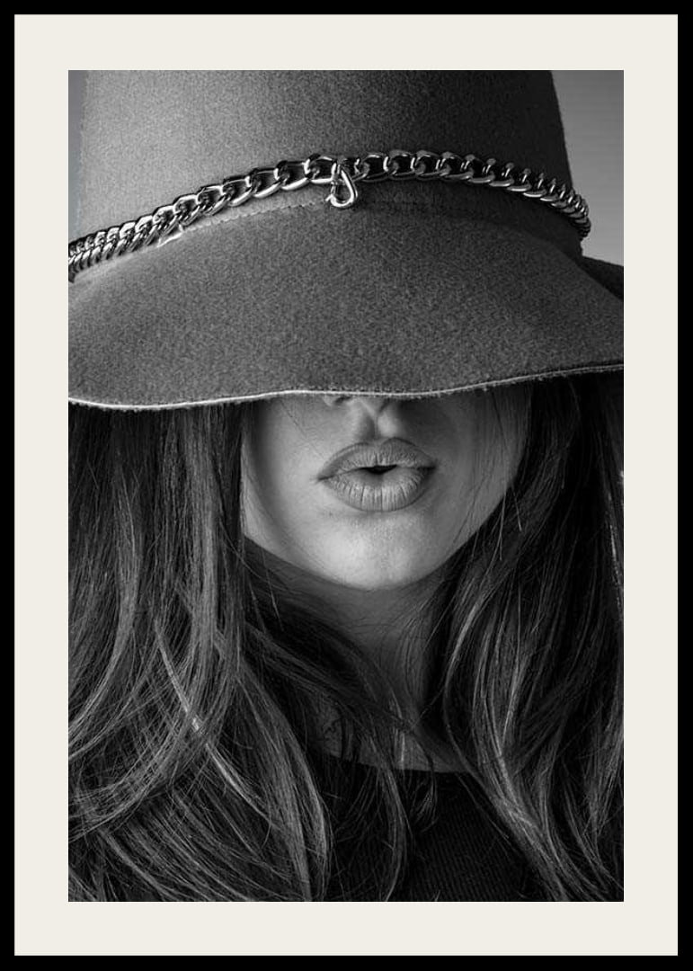 Black and white fashion image of woman with big hat and long hair-12