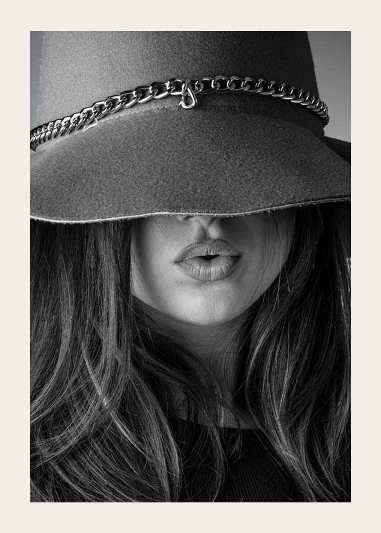 Black and white fashion image of woman with big hat and long hair-12