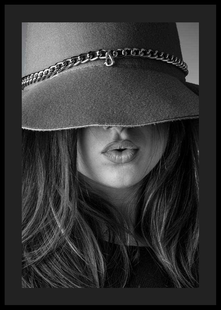 Black and white fashion image of woman with big hat and long hair-12
