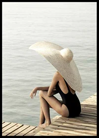 Photograph of woman in black swimsuit with large bright hat-6