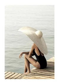 Photograph of woman in black swimsuit with large bright hat-1