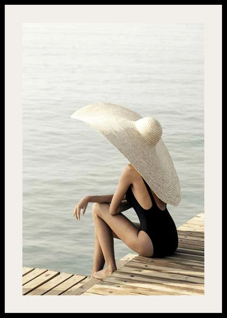Photograph of woman in black swimsuit with large bright hat-12