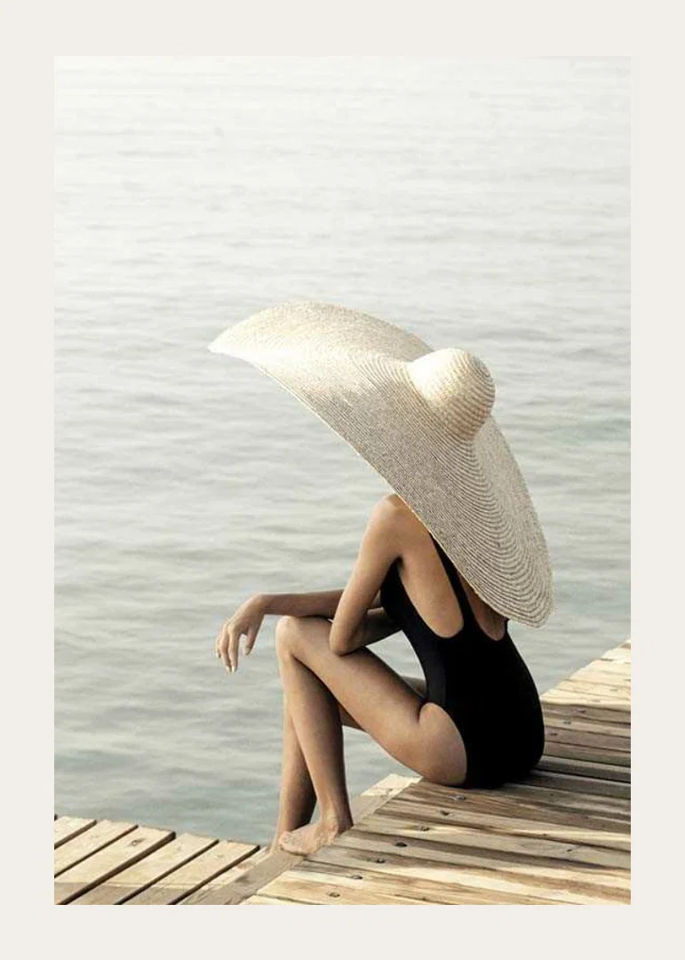 Photograph of woman in black swimsuit with large bright hat-12