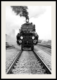 Black and white photograph of steam locomotive running straight towards the camera-2