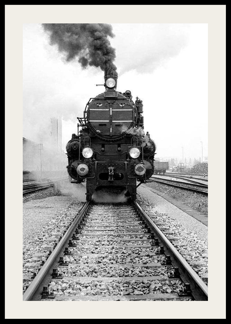 Black and white photograph of steam locomotive running straight towards the camera-12