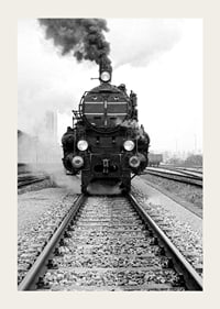 Black and white photograph of steam locomotive running straight towards the camera-3