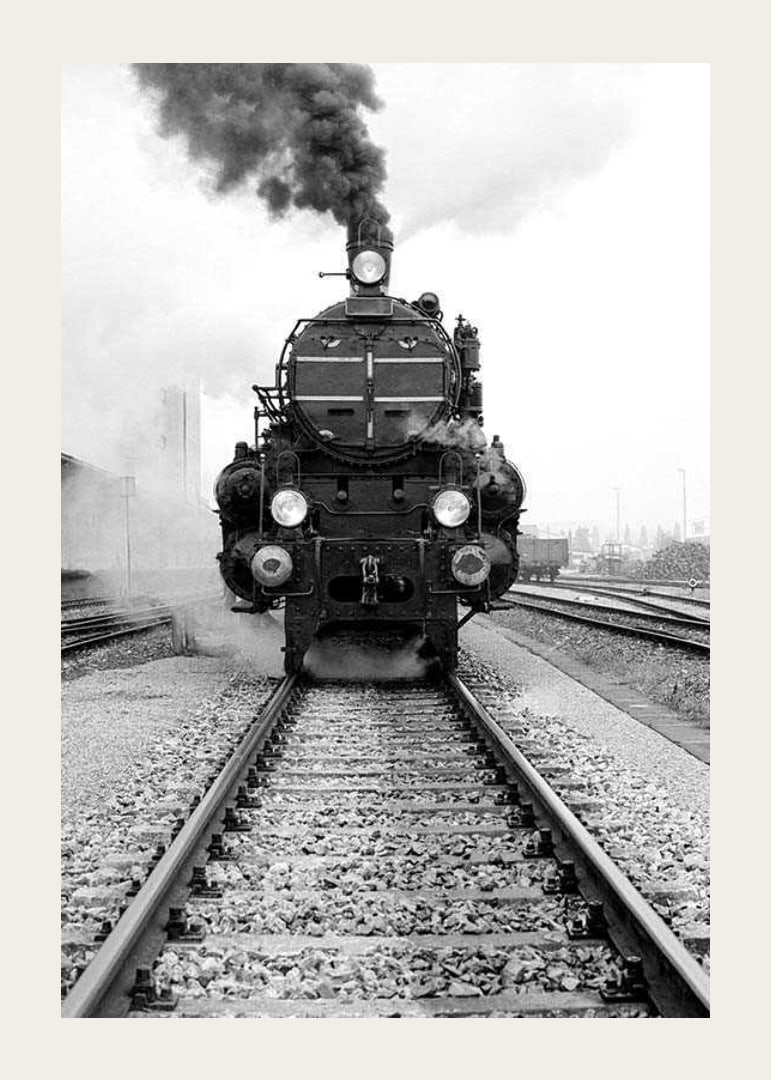 Black and white photograph of steam locomotive running straight towards the camera-12