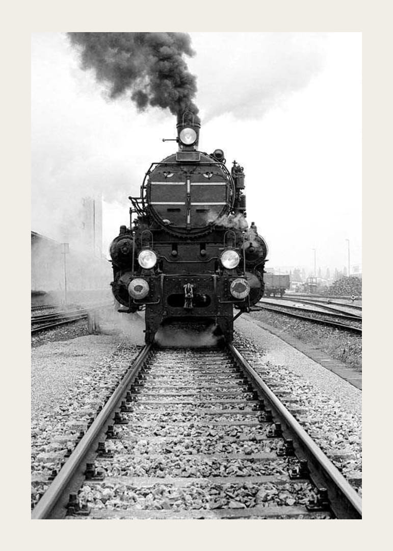 Svartvit fotografi av ånglok som kör rakt mot kameran-12