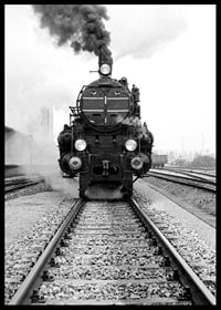 Black and white photograph of steam locomotive running straight towards the camera-6
