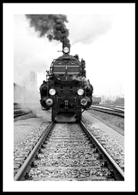 Black and white photograph of steam locomotive running straight towards the camera-0
