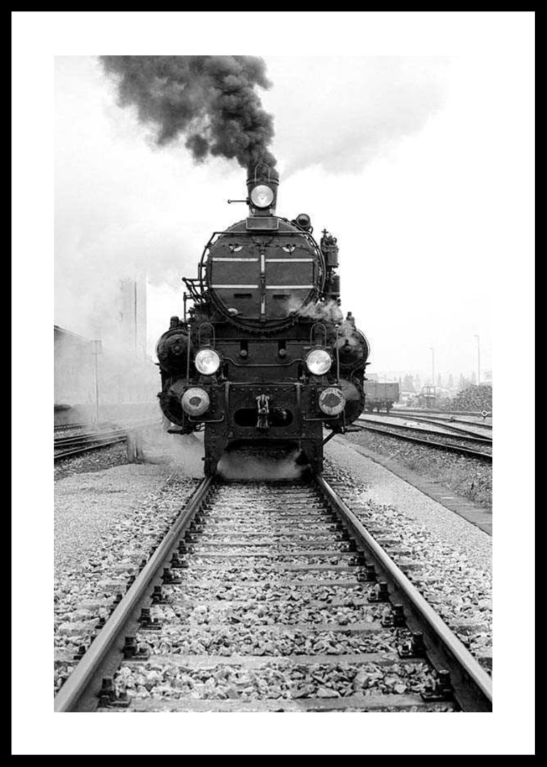 Black and white photograph of steam locomotive running straight towards the camera-12