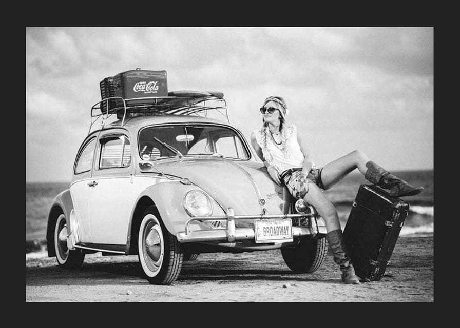 Black and white vintage photograph of woman by Volkswagen Beetle-12