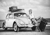 Black and white vintage photograph of woman by Volkswagen Beetle-7