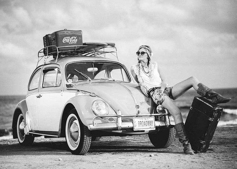 Black and white vintage photograph of woman by Volkswagen Beetle-12