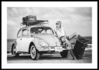Black and white vintage photograph of woman by Volkswagen Beetle-0
