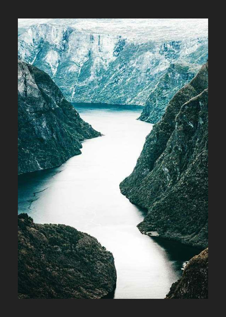 Fotografická fjordová krajina so strmými horami a modrými tónmi-12