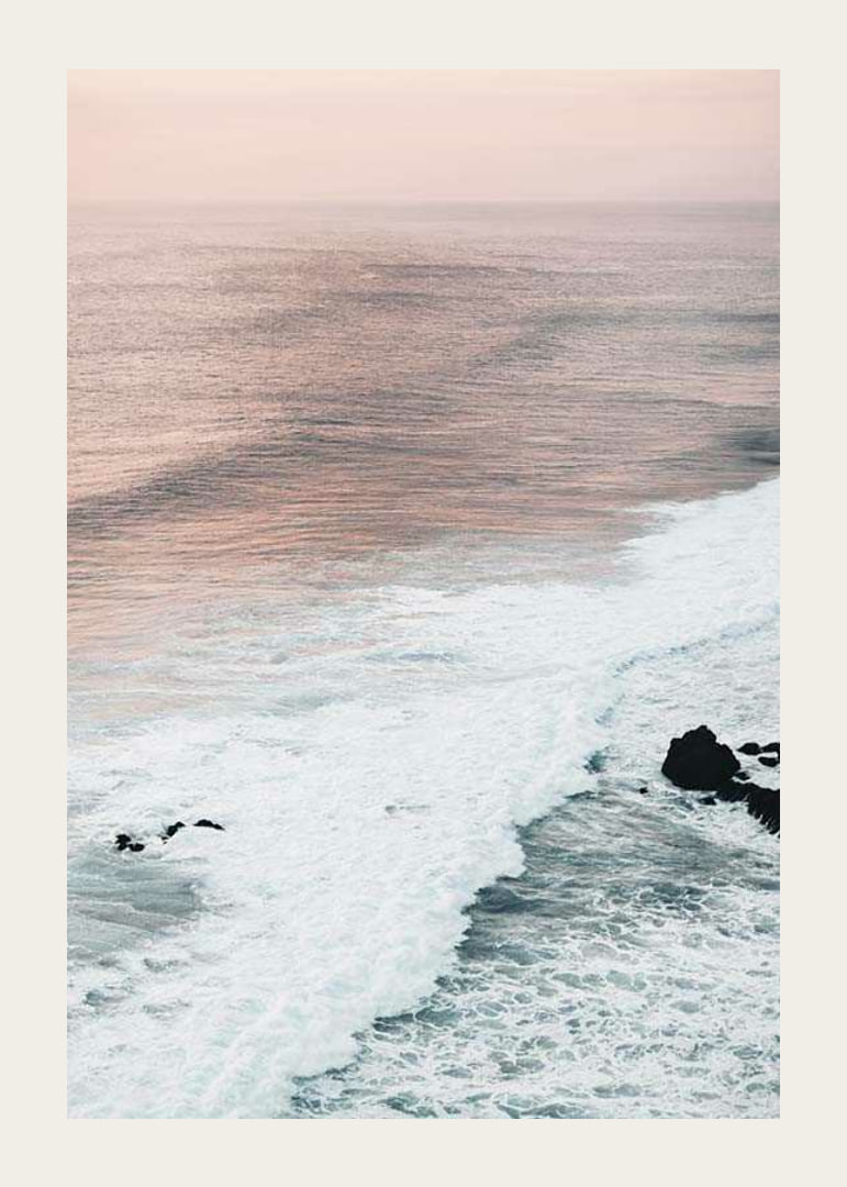 Photograph of ocean waves against coastal rocks in soft pink tones-12
