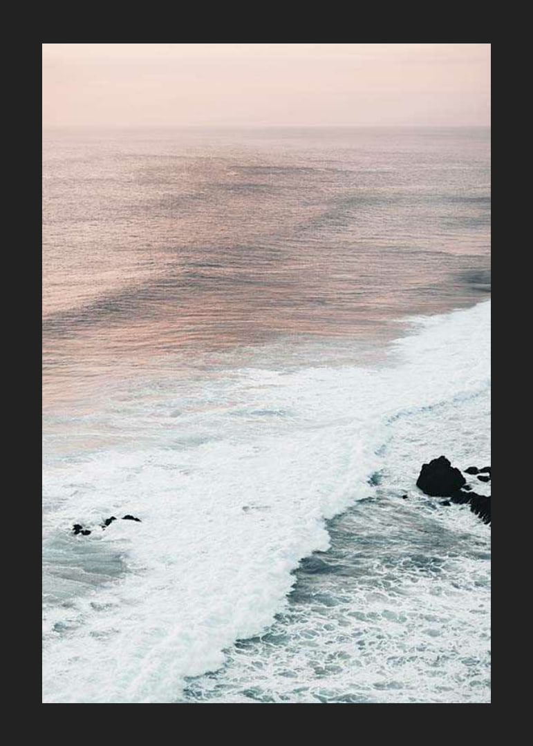 Photograph of ocean waves against coastal rocks in soft pink tones-12