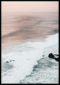 Photograph of ocean waves against coastal rocks in soft pink tones-6