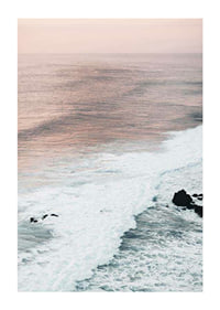 Photograph of ocean waves against coastal rocks in soft pink tones-1
