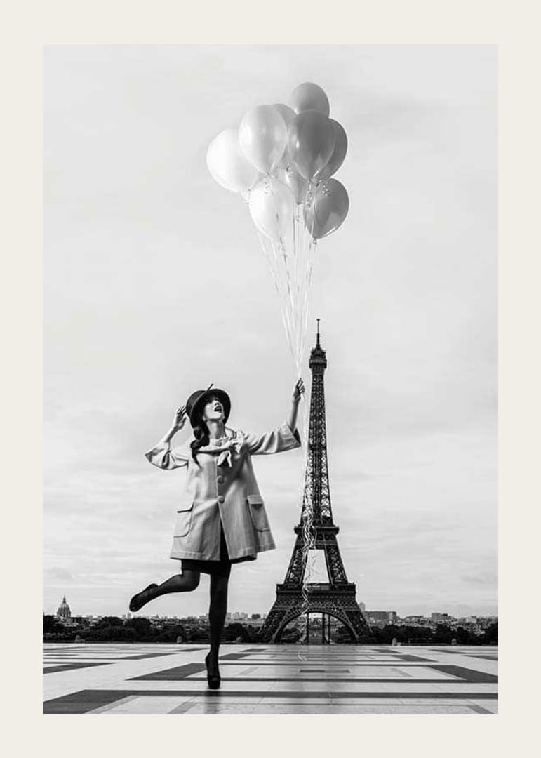 Black and white photo of woman with balloons at the Eiffel Tower-12