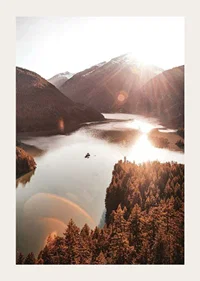 Photograph of sunlit lake surrounded by forested mountains-3