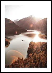 Photograph of sunlit lake surrounded by forested mountains-0