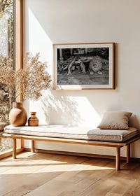 Black and white photograph of young man and lion on floor indoors-8