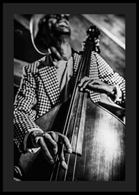 Black and white close-up of man in checkered jacket playing double bass-4
