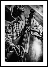 Black and white close-up of man in checkered jacket playing double bass-0