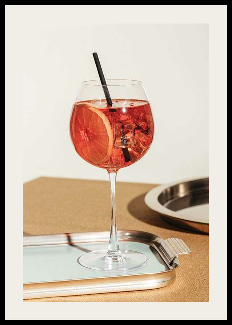 Close-up of Aperol Spritz in wine glass with orange slice-12