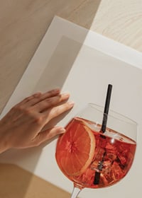 Close-up of Aperol Spritz in wine glass with orange slice-9