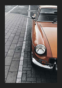 Close-up of orange classic car parked on cobblestones-5