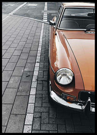 Close-up of orange classic car parked on cobblestones-6