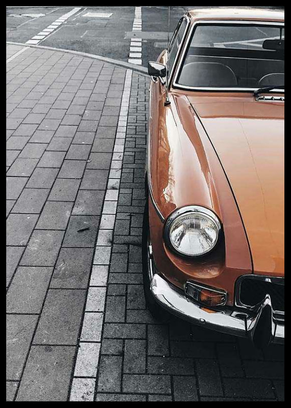 Close-up of orange classic car parked on cobblestones-12